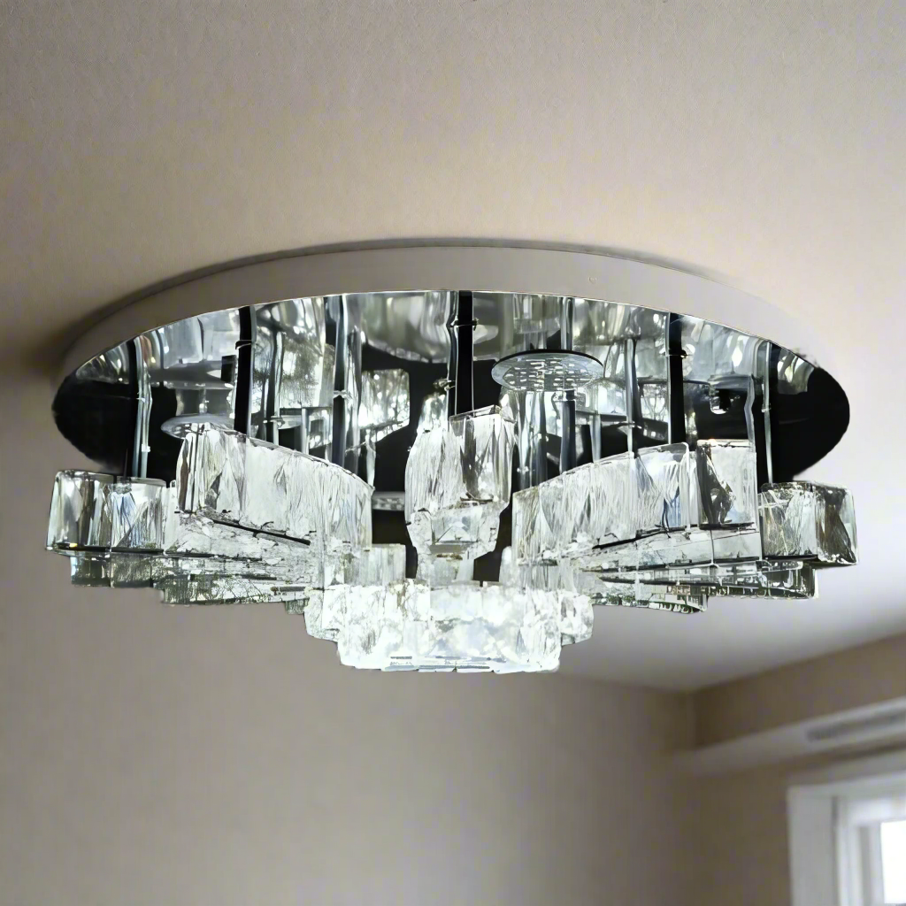 A rectangular crystal chandelier with a mirror base and rows of hanging clear glass prisms, suspended from a dark ceiling and glowing with bright white light; suitable for large rooms or dining areas.