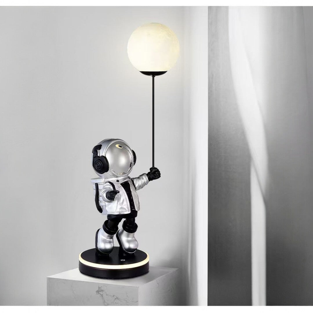 Astronaut lamp holding a light bulb on a gray background