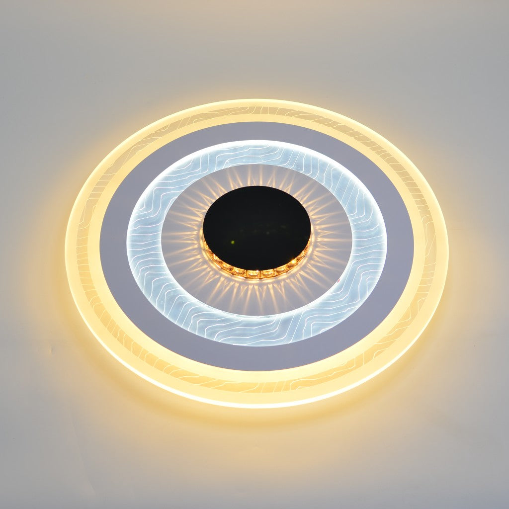 A circular ceiling light featuring concentric LED rings in warm yellow and white with a black center.
