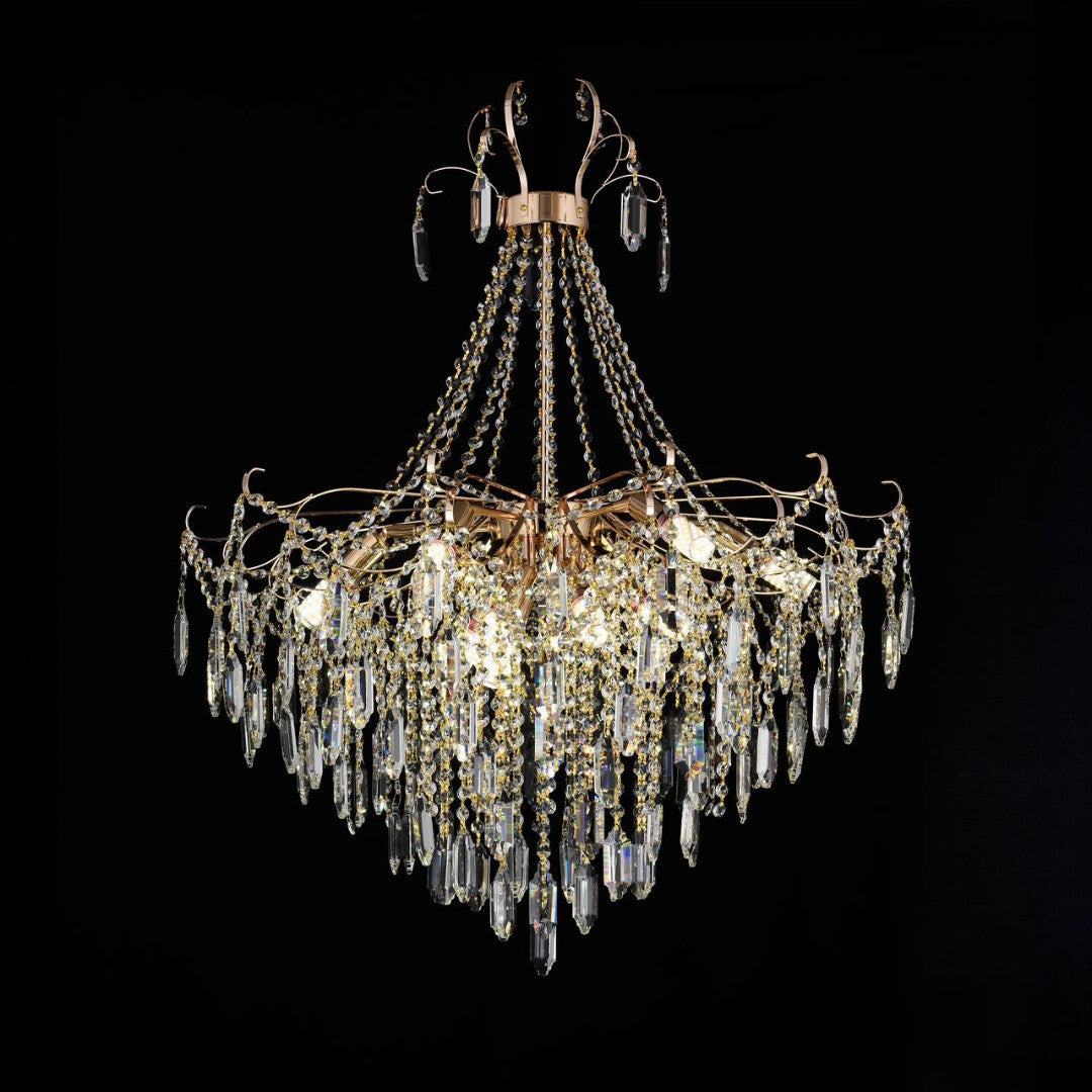 Classic gold and crystal chandelier with layered hanging prisms and chain detailing, ideal for luxurious interiors.