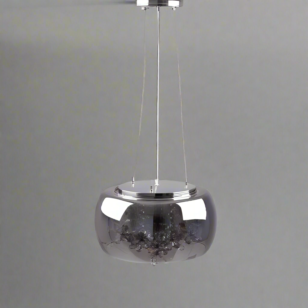 A sleek and minimalist metallic pendant light with a reflective chrome dome-shaped shade, suspended by a thin white cord against a plain light grey background.