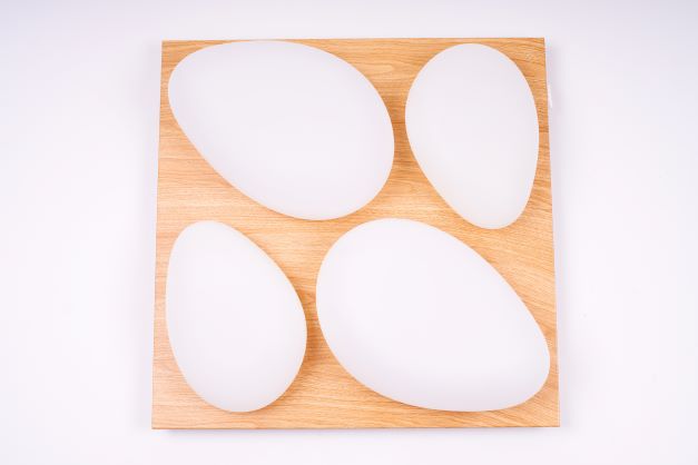 A small image showing a modern flush-mount ceiling light with four rounded triangular LED panels arranged in a symmetrical clover shape. The fixture is mounted flush against a light-colored ceiling, suitable for bedrooms, living rooms, or cozy indoor spaces.