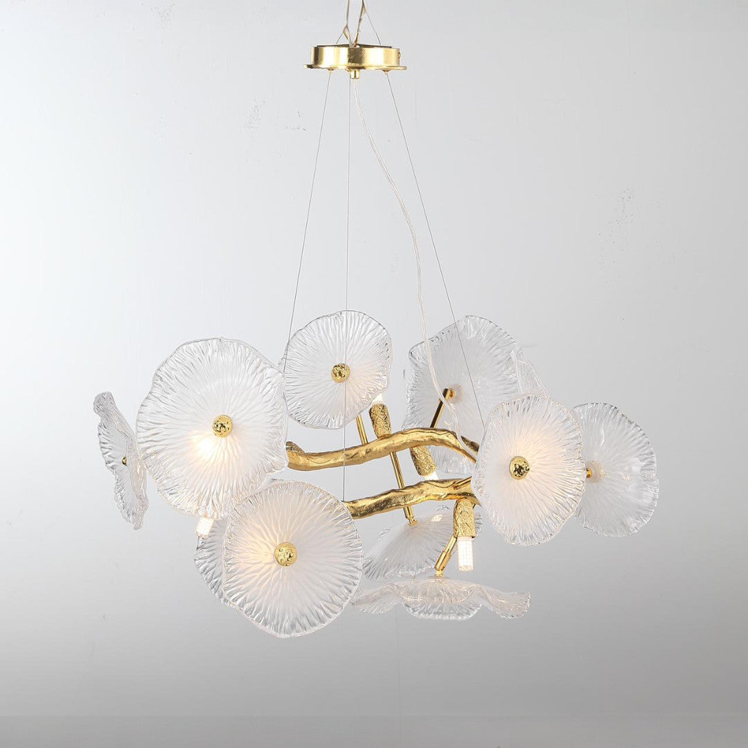 A contemporary chandelier with white glass flower-shaped lampshades and a gold frame.