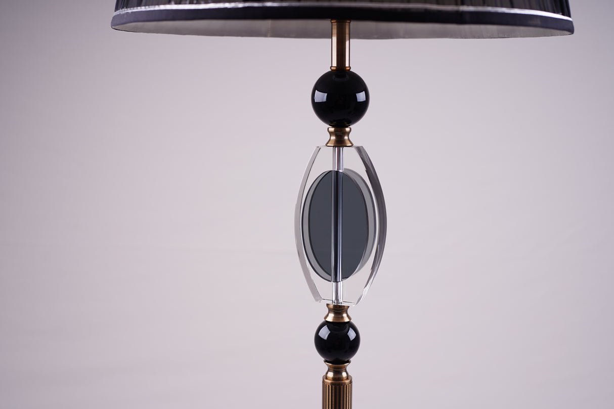 A close-up of the black and crystal accent details of the elegant floor lamp with a black lampshade.