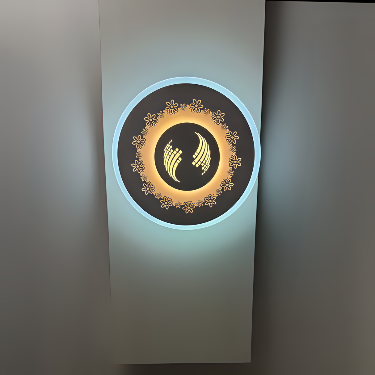 White round wall lamp featuring a small flower motif, mounted on a white wall.