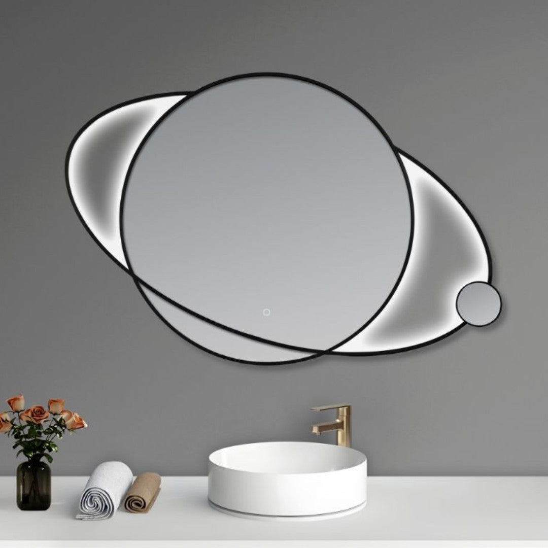 Modern round mirror with black frame on a gray wall above a white sink.