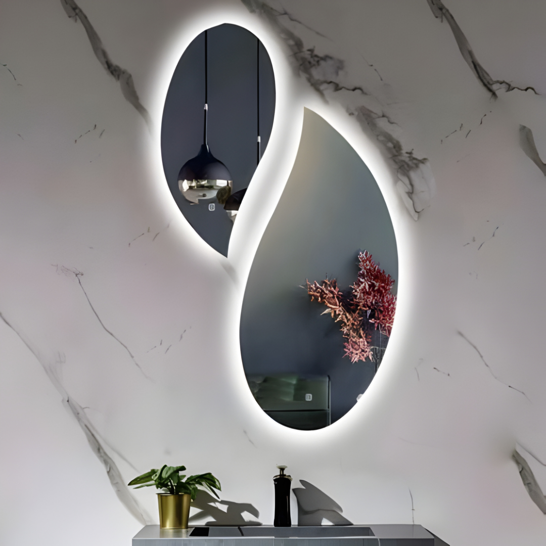 Modern bathroom with a large oval mirror with lights, sink, and decorative elements.