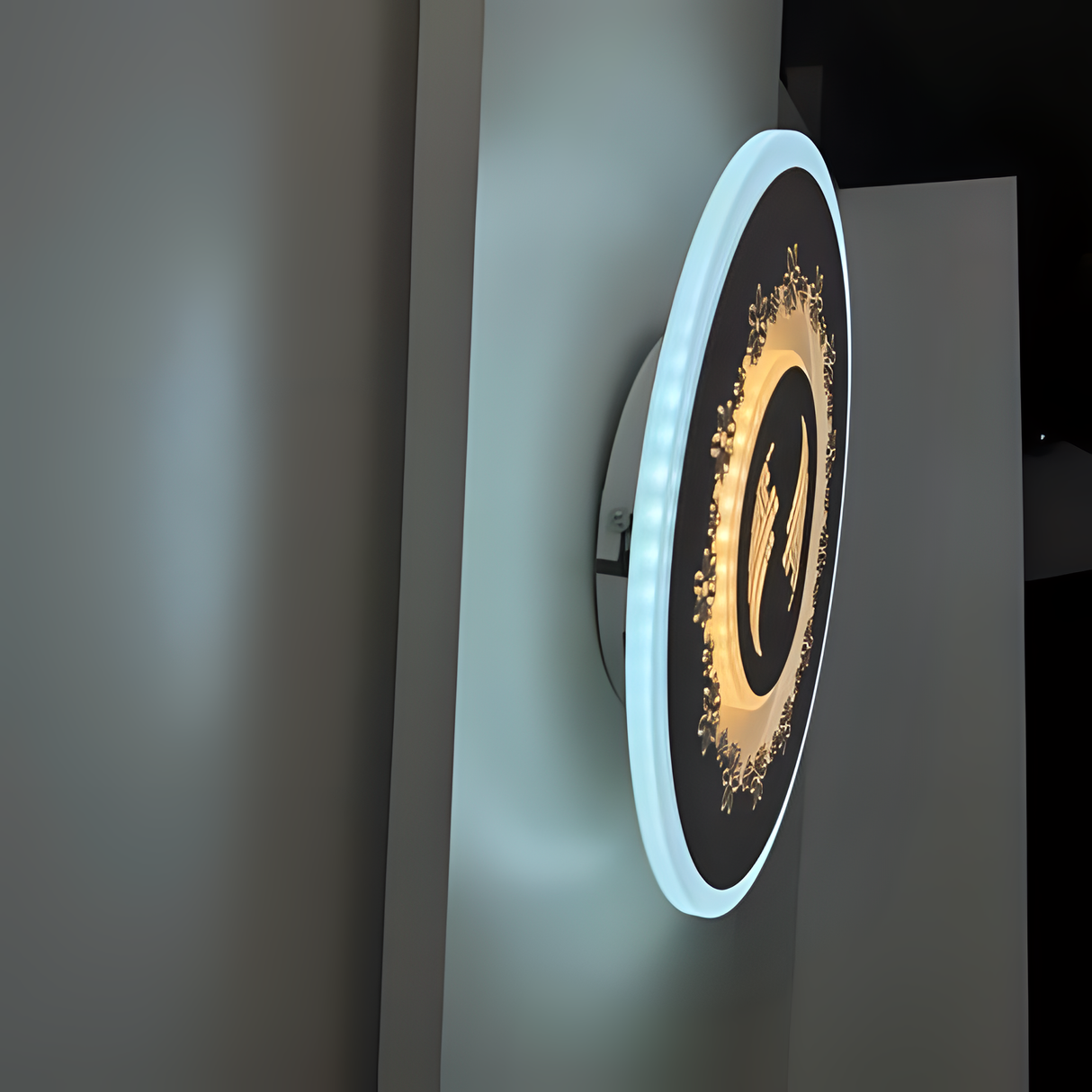 White round wall lamp featuring a small flower motif, mounted on a white wall.