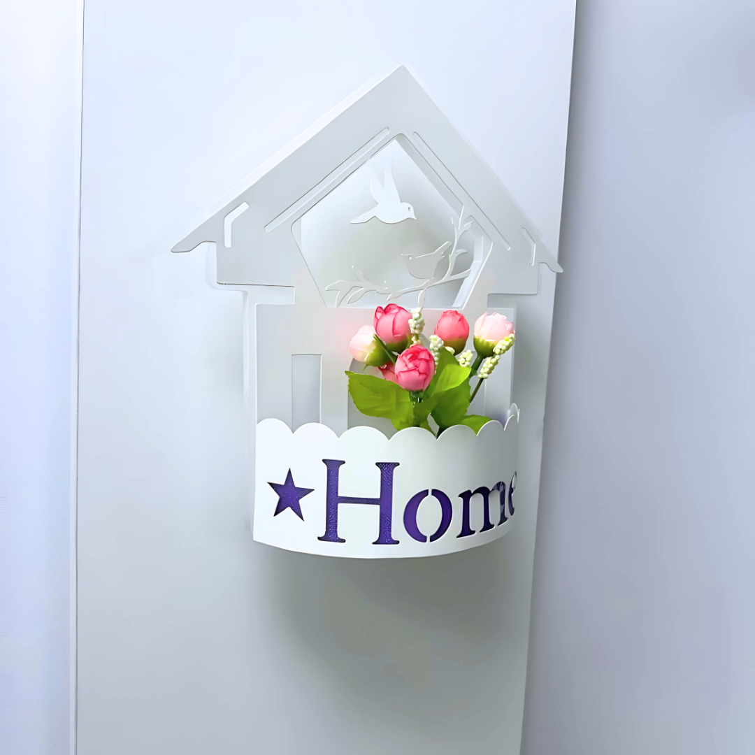 Wall-mounted LED light fixture designed in the shape of a white house , featuring a cork-style built-in compartment holding artificial pink and red tulip flowers.