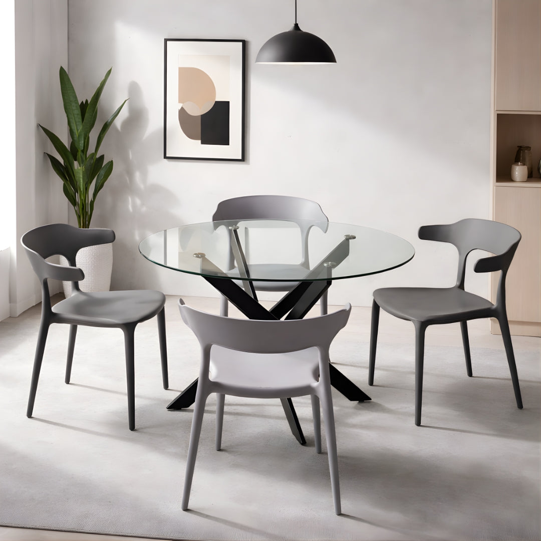 Modern dining room with a glass table and gray chairs.