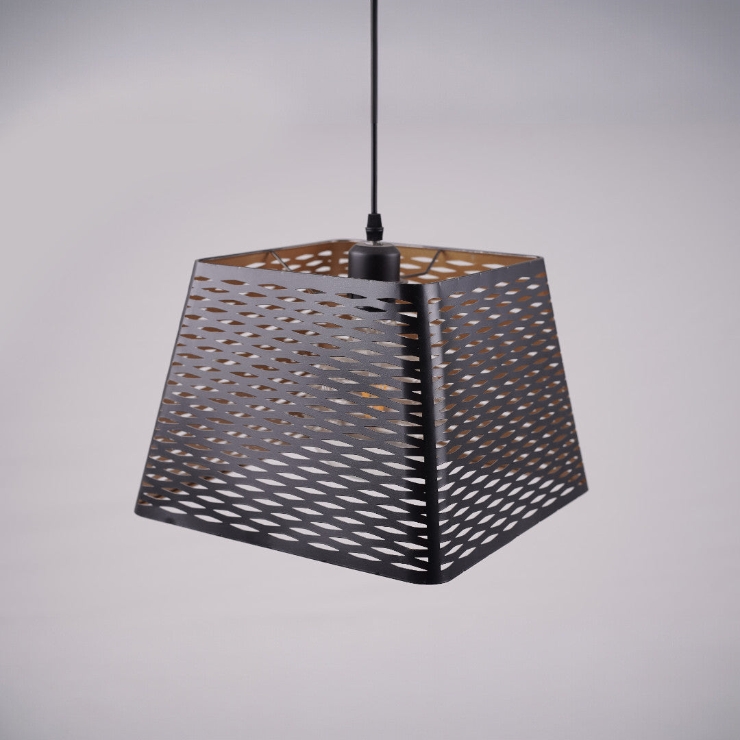 A black metal pendant light with a similar trapezoidal mesh shade, unlit, hanging from a black cord against a light gray background, showcasing its geometric and industrial design.