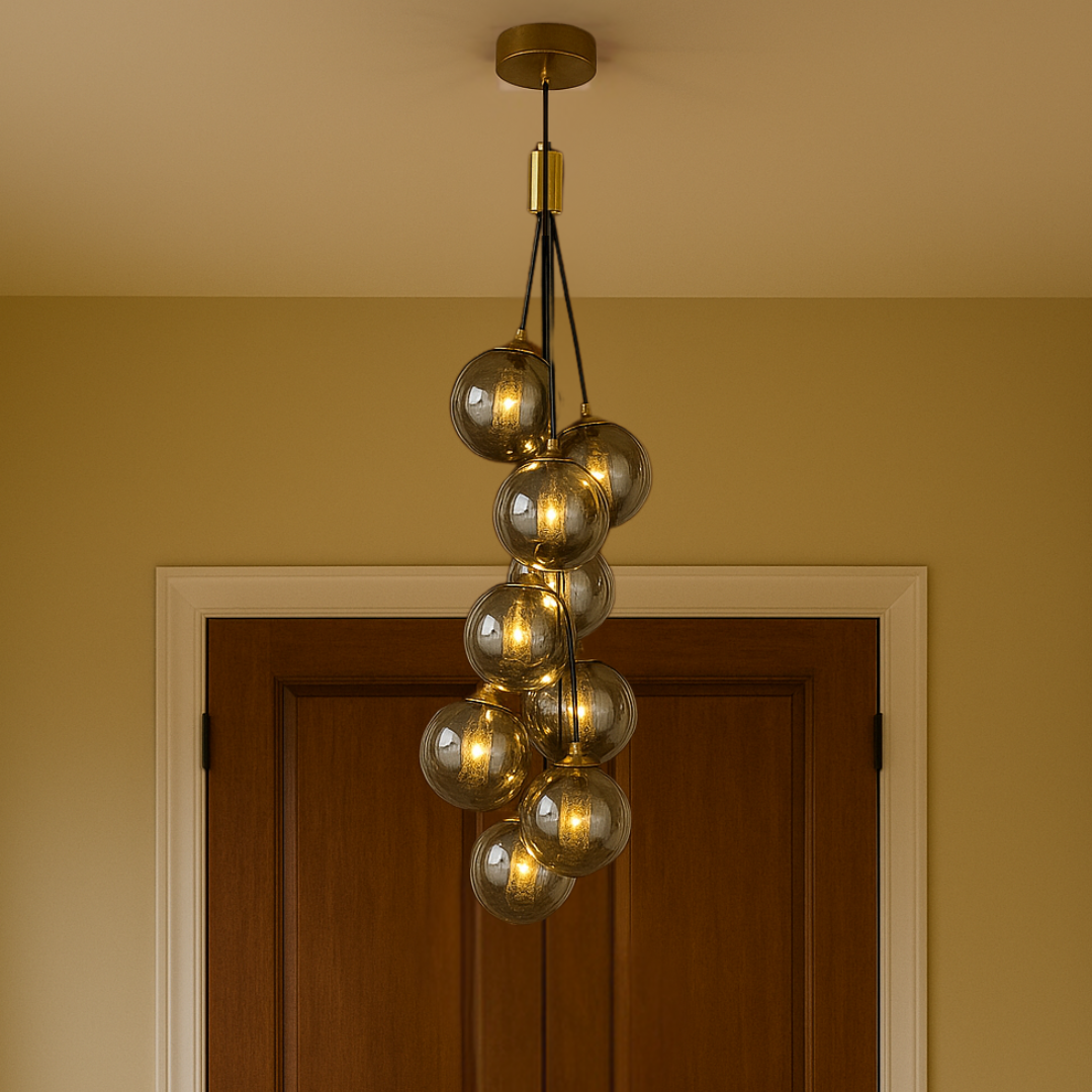 Chandelier with glass bulbs hanging from the ceiling in a room with a door and beige walls.