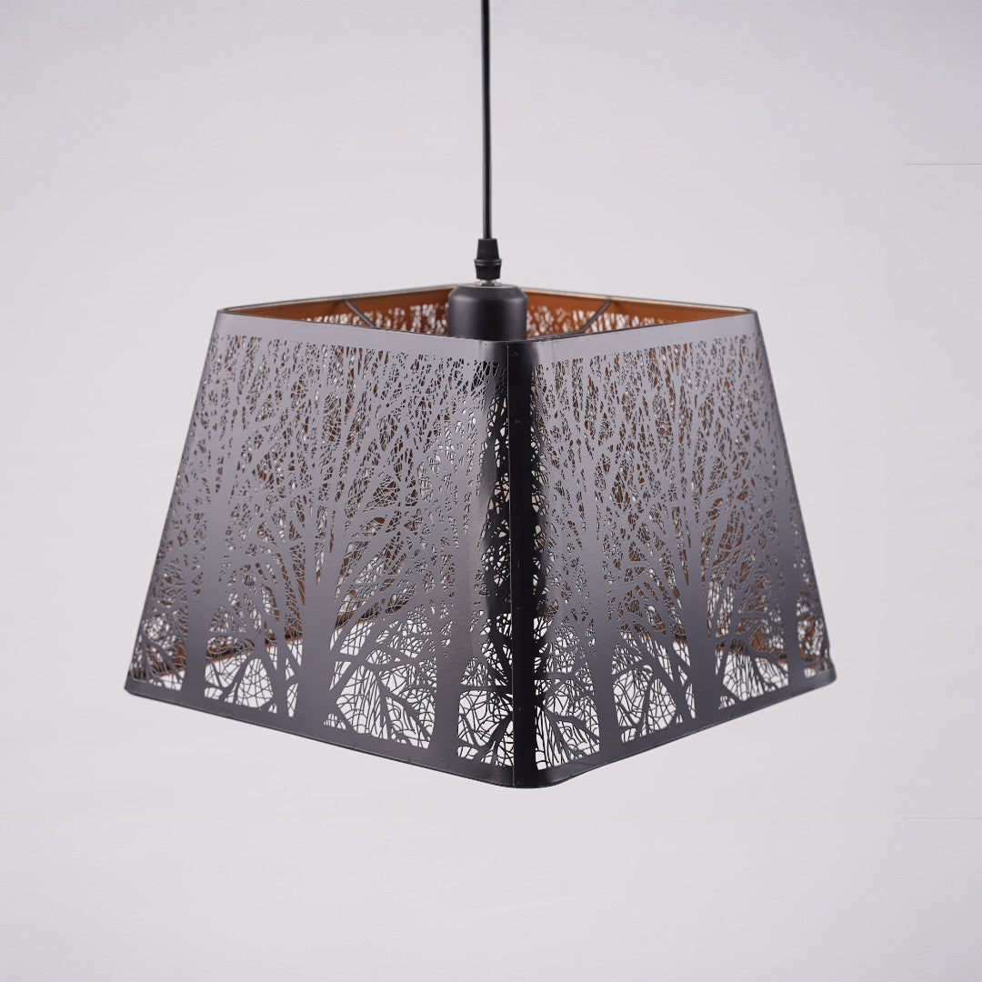A black square-shaped pendant lampshade with intricate tree patterns cut into the metal frame.