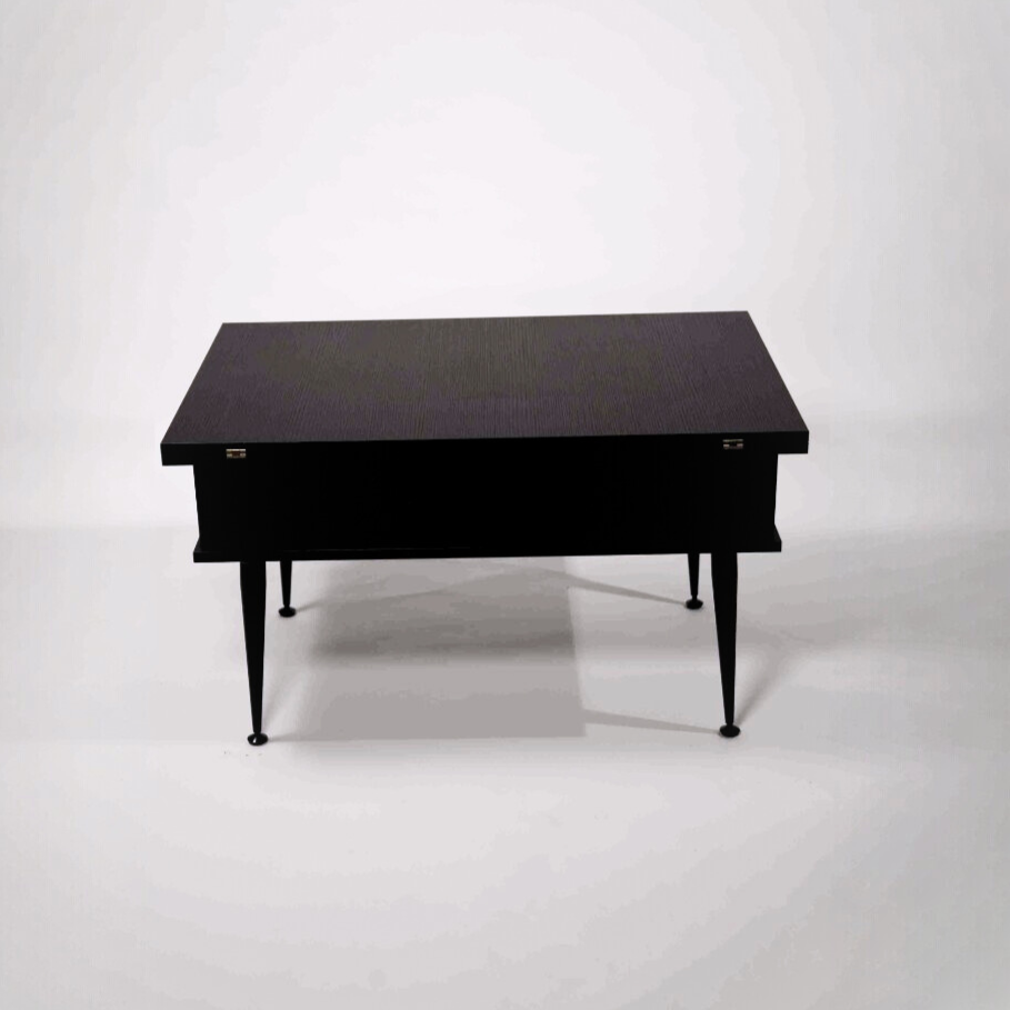Black table with metal legs on a white background