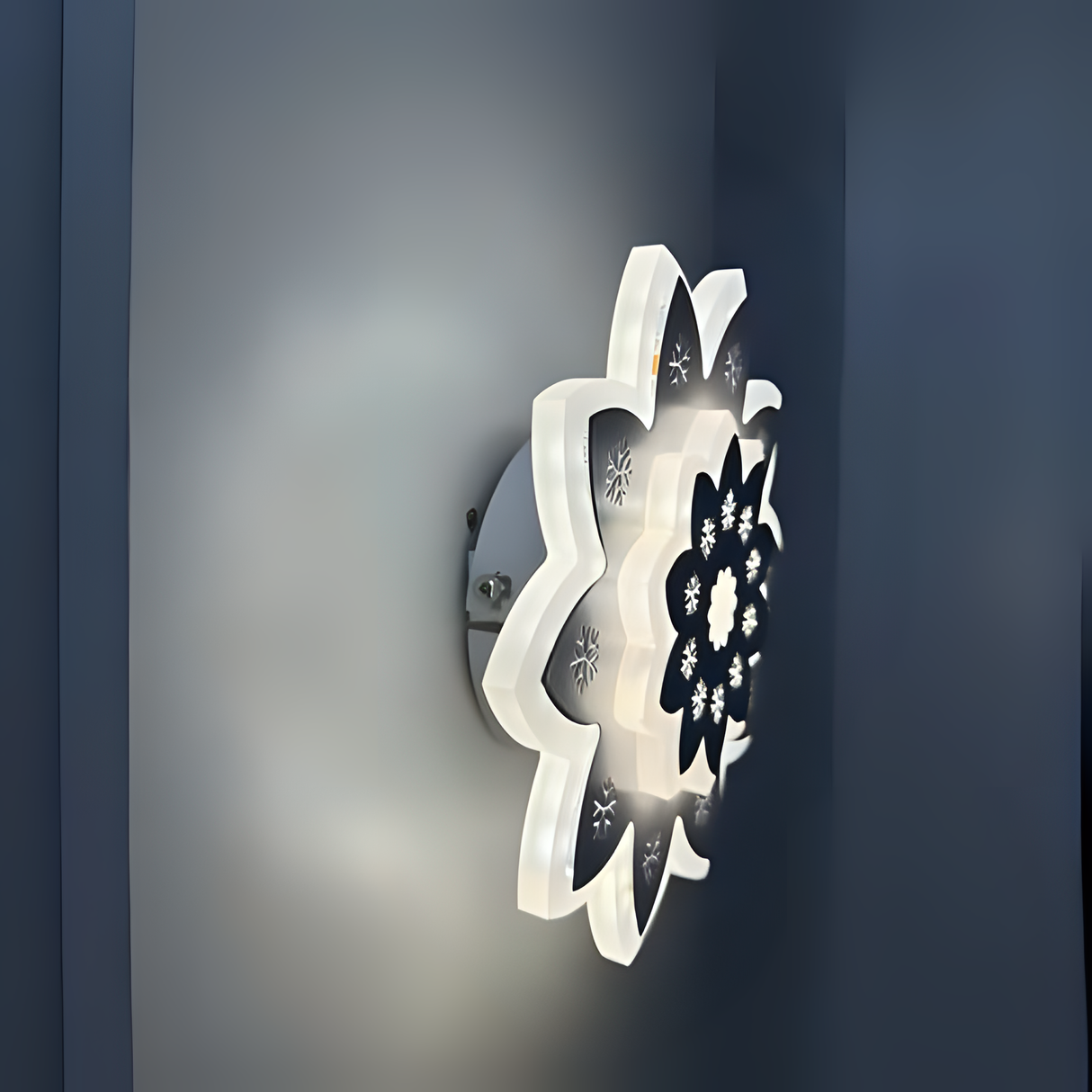 Modern Flower LED Wall Light in a sleek flower shape, crafted from metal and acrylic, fixed on a white wall, emitting soft, warm white light.