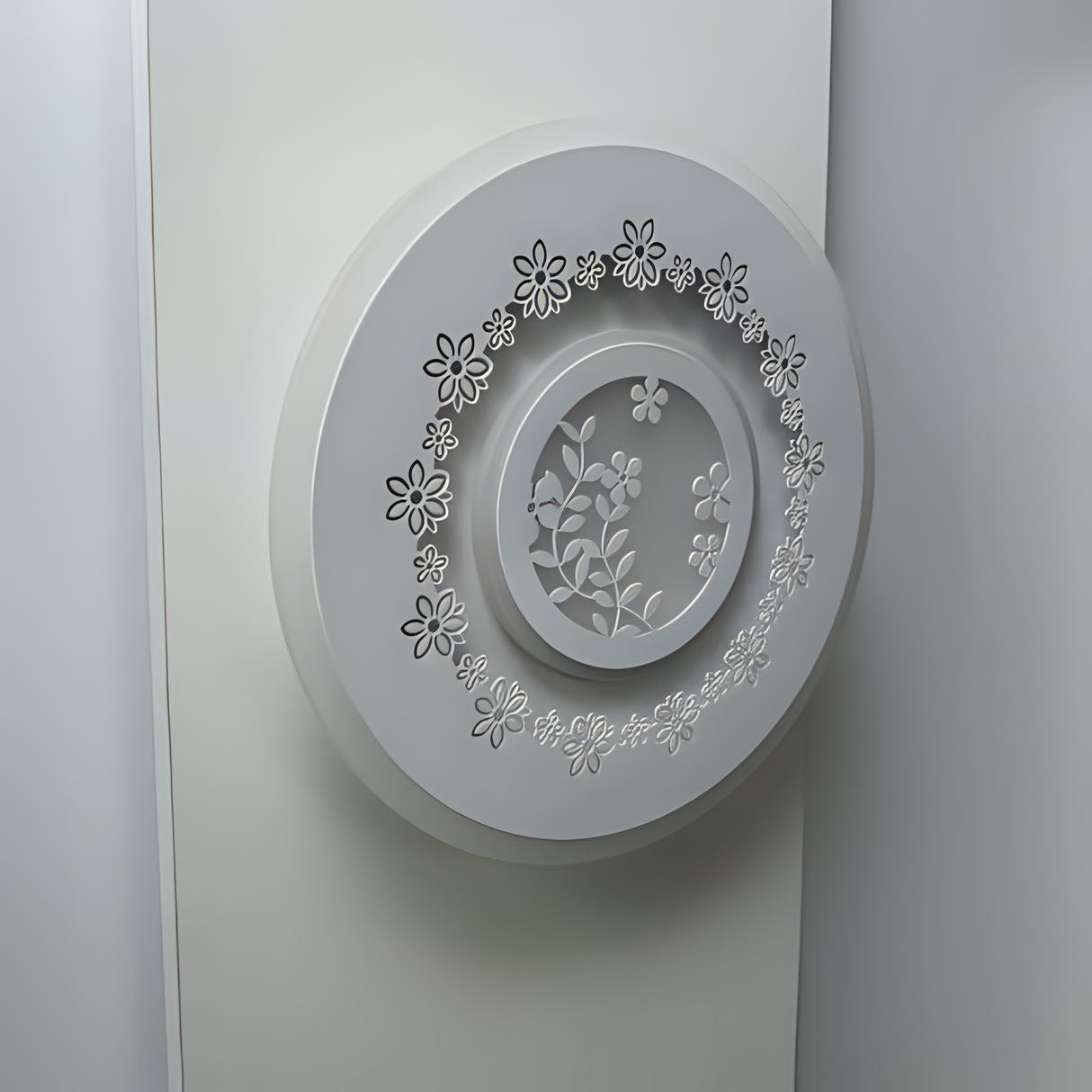 White round wall lamp featuring a small flower motif, mounted on a white wall.