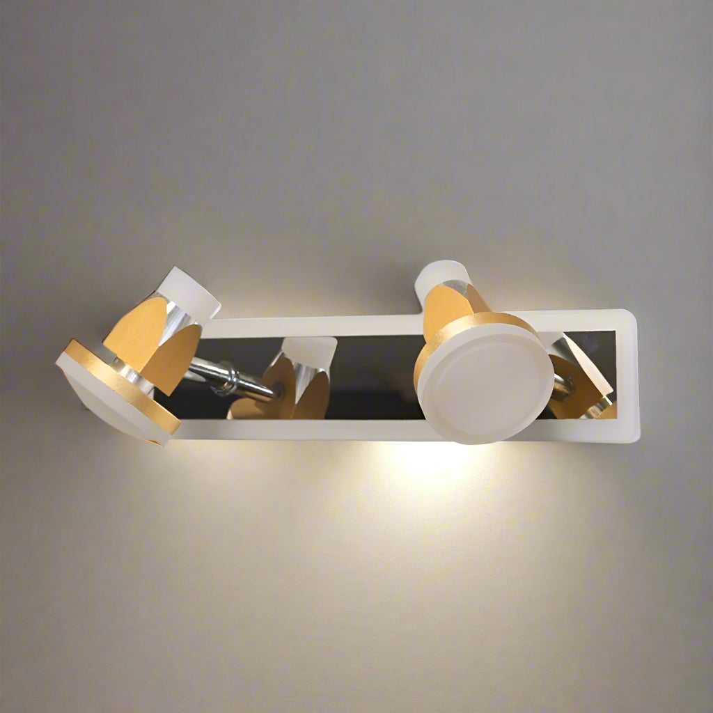 A minimalist two-light wall sconce with a sleek, rectangular reflective metal base, holding two adjustable yellow-toned cylindrical lampshades.