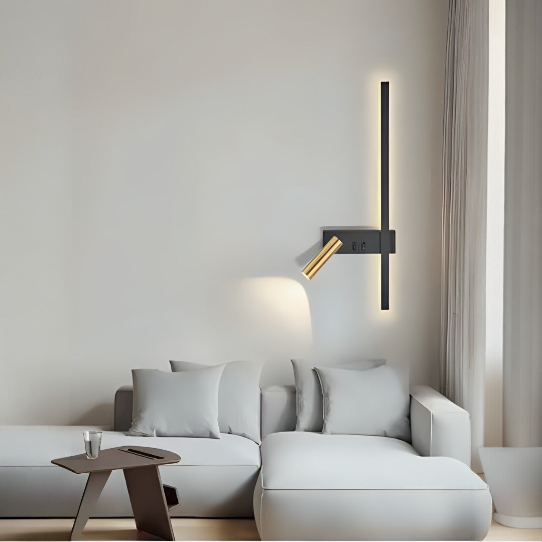 A modern bedside wall lamp with a sleek black base, a vertical LED bar for ambient lighting, and an adjustable gold spotlight for focused illumination.