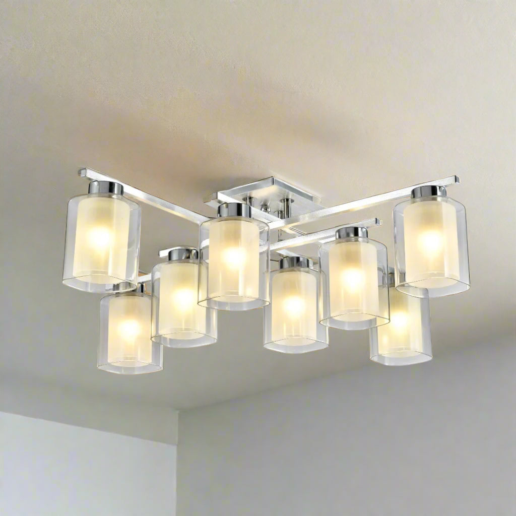 Multi-light rectangular chandelier with ten cylindrical frosted glass shades in two rows, mounted on a chrome base.