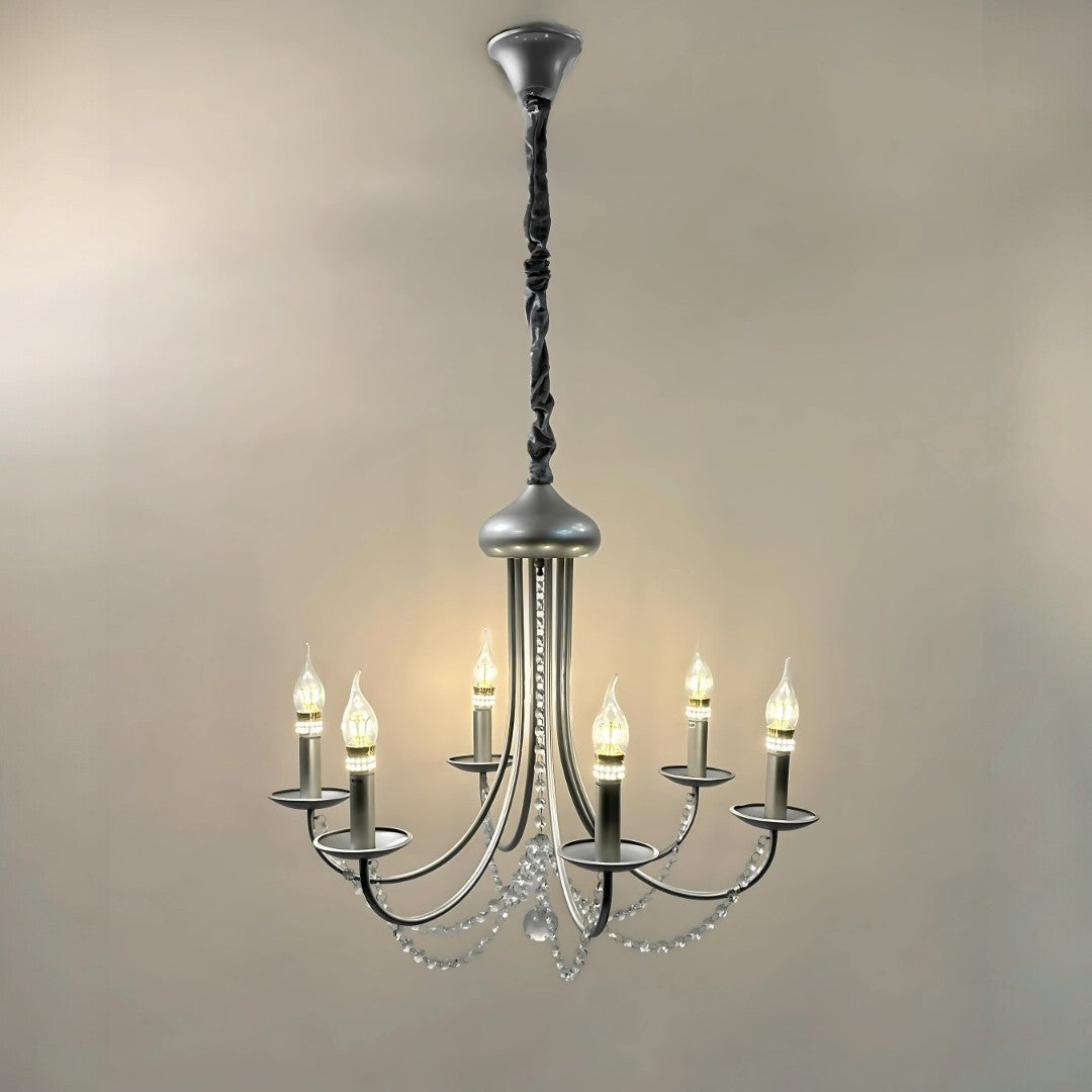 Classic six-arm chandelier with candle-style LED bulbs, black curved arms, and draped crystal bead chains, suspended from a black fabric-wrapped rod against a neutral background.
