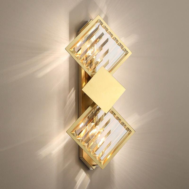 A modern gold and crystal wall light with a stacked diamond design, creating a luxurious ambiance.
