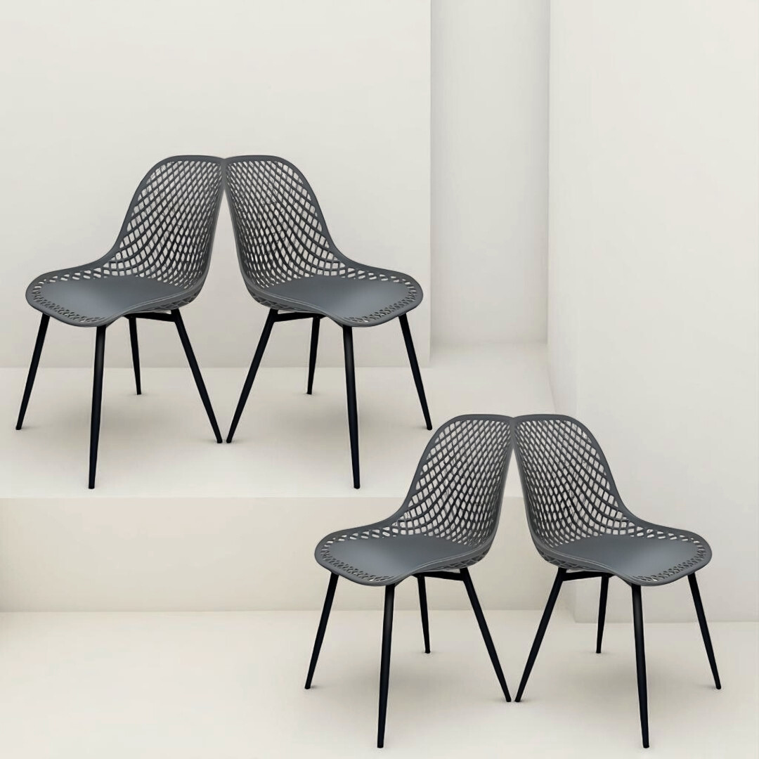 four dark grey mesh-style chairs with black legs, positioned in a mirrored pose on staggered white platforms.