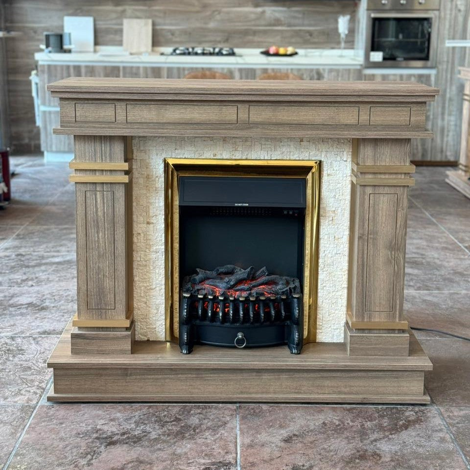 Asymmetrical wooden fireplace with gold trim and a black electric firebox, designed with a polished and luxurious appearance.
