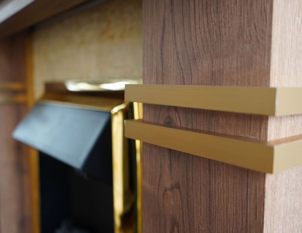 A close-up of a wooden fireplace frame with gold detailing, showcasing intricate craftsmanship.