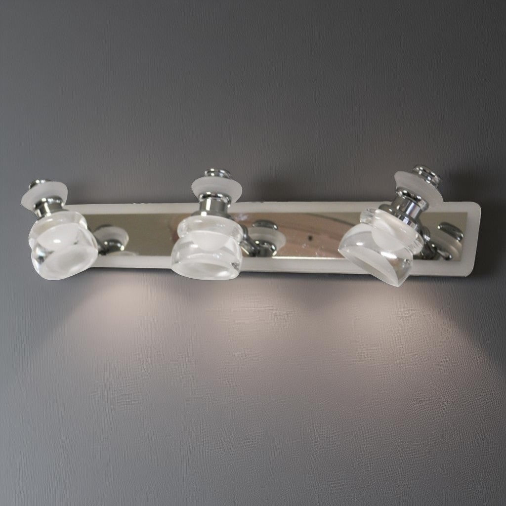 A sleek and contemporary triple-led bulb chrome wall light fixture with clear glass shades, mounted on a metallic base.