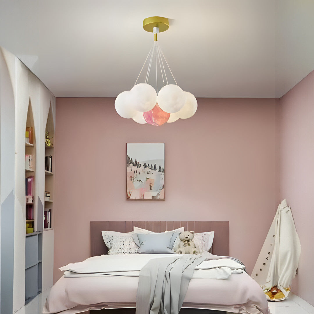 A cloud-inspired pendant light fixture with multiple frosted white globes, creating a soft and airy look.