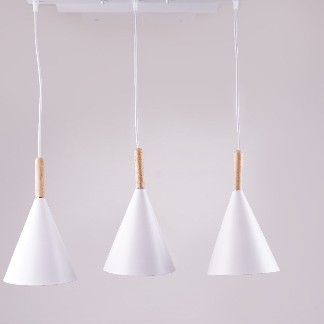 Three identical white cone-shaped pendant lights hanging from a white ceiling mount.