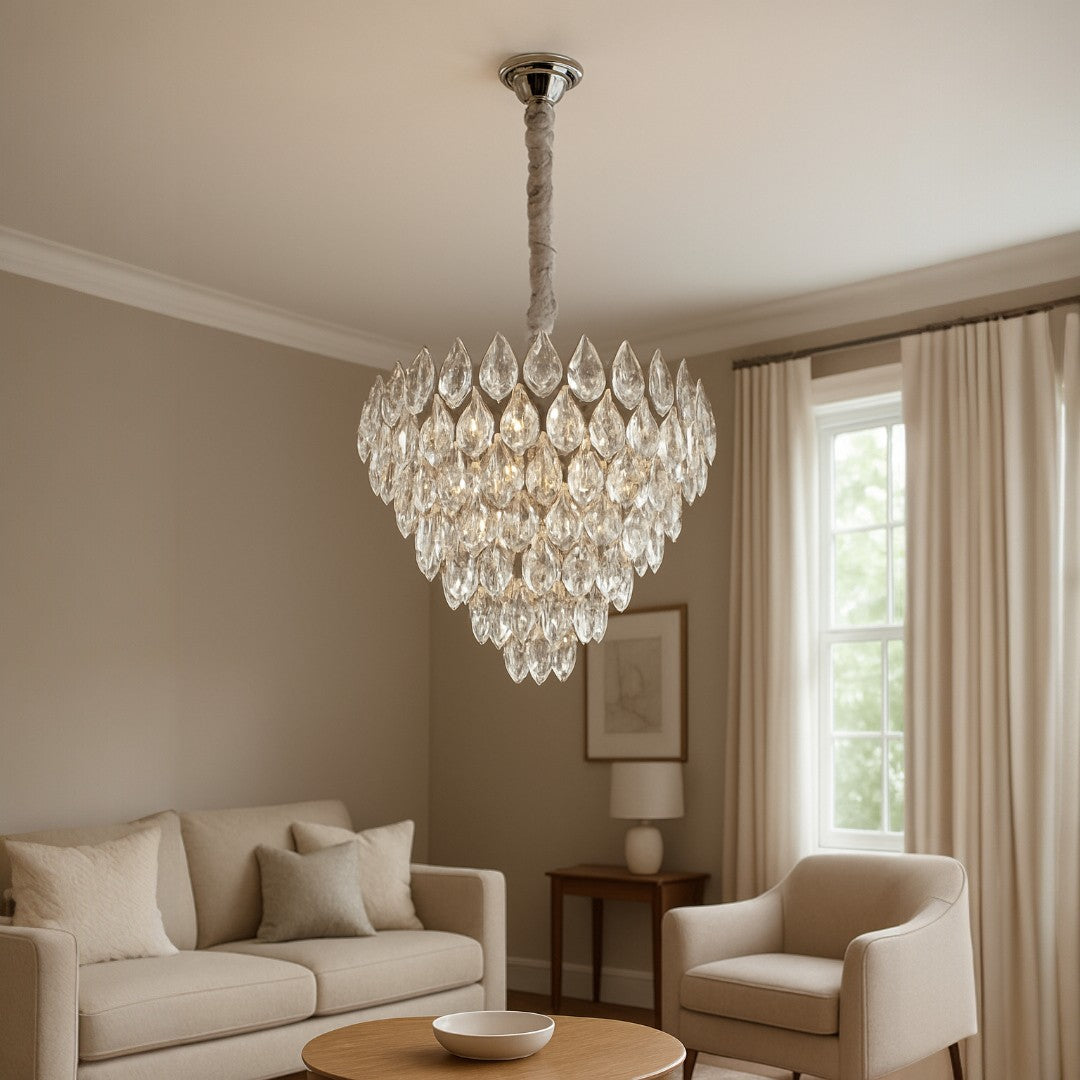 Chandelier hanging in a living room with beige sofa and armchair.