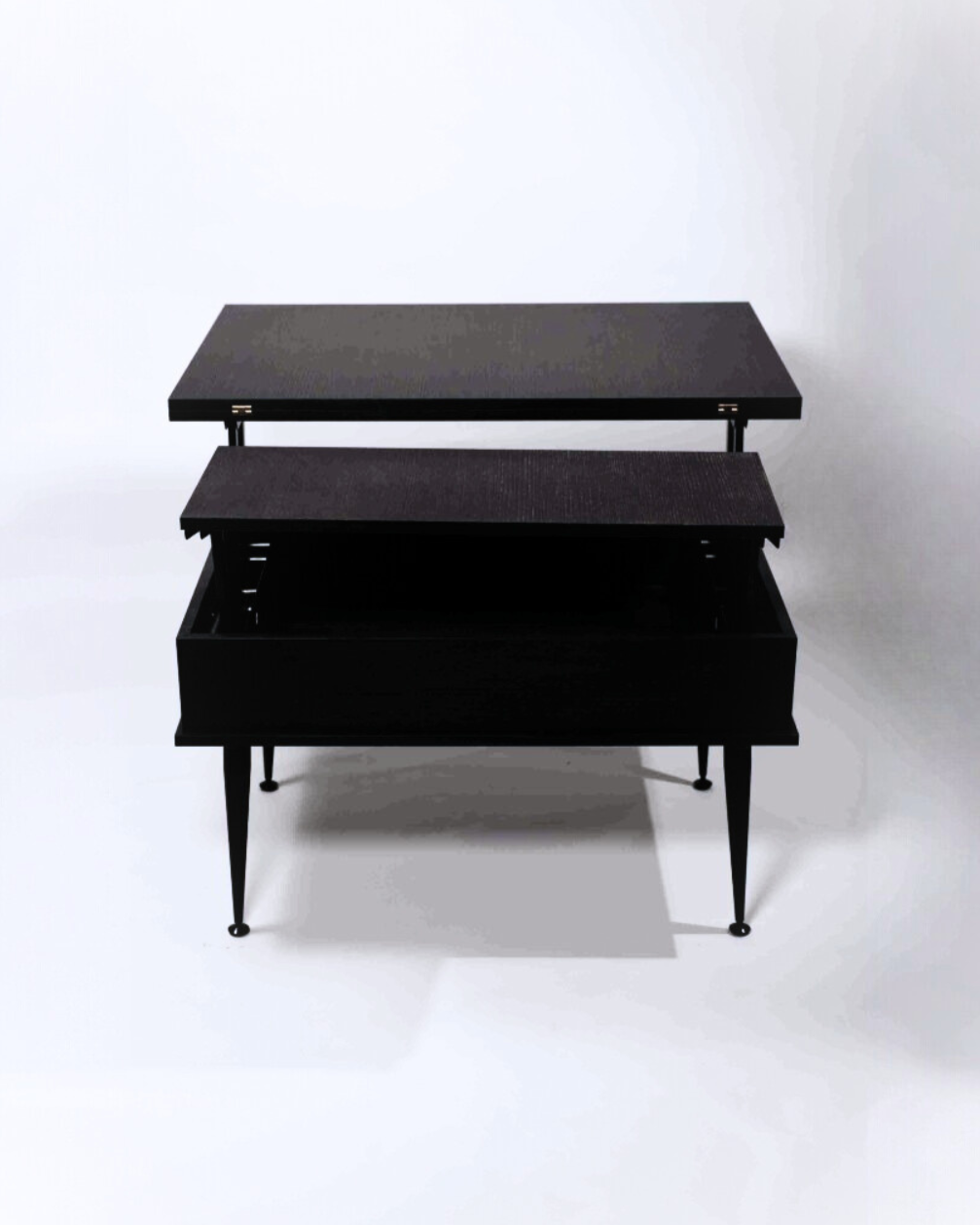 A black smart table, partially open, revealing two wooden panels, with metal legs on a white background.