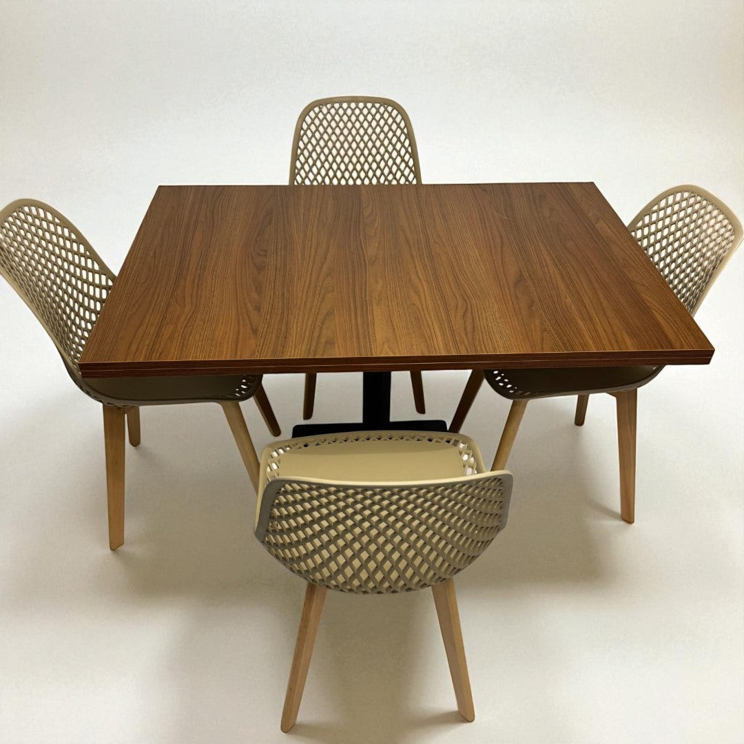 Wooden dining table with four chairs on a white background