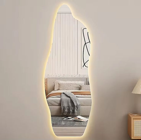 Oval-shaped mirror with LED lighting in a room with a sofa and lamp.