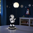 Spaceman lamp with a round light bulb on a dark background