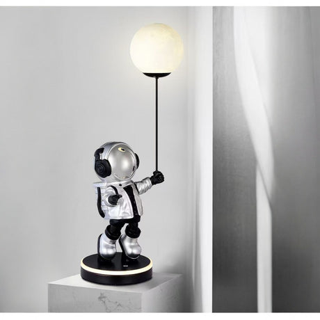 Astronaut lamp holding a light bulb on a gray background