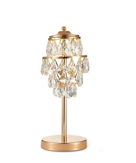 This table lamp features a gold base with a slender stem, topped by cascading crystal pendants arranged in tiers. The design combines structured elegance with a luxurious, chandelier-like aesthetic.