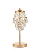 This table lamp features a gold base with a slender stem, topped by cascading crystal pendants arranged in tiers. The design combines structured elegance with a luxurious, chandelier-like aesthetic.