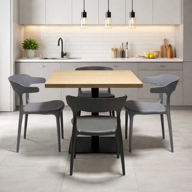 Dining area with a wooden table and gray chairs in a modern kitchen.