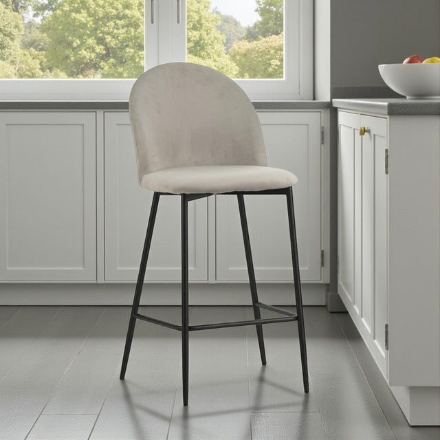 Beige bar stool with black legs in a kitchen setting