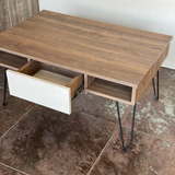 Side view of the table with the central white drawer pulled out, revealing its storage capacity and sturdy metal legs