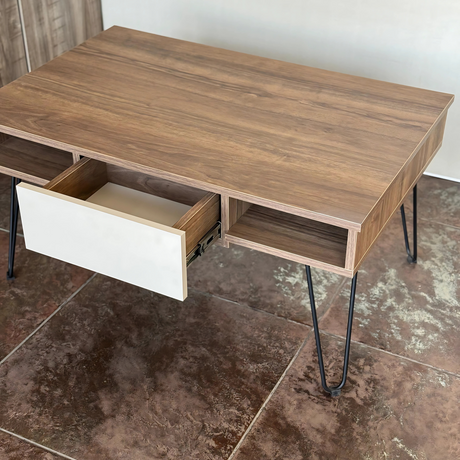 Side view of the table with the central white drawer pulled out, revealing its storage capacity and sturdy metal legs