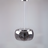 A sleek and minimalist metallic pendant light with a reflective chrome dome-shaped shade, suspended by a thin white cord against a plain light grey background.