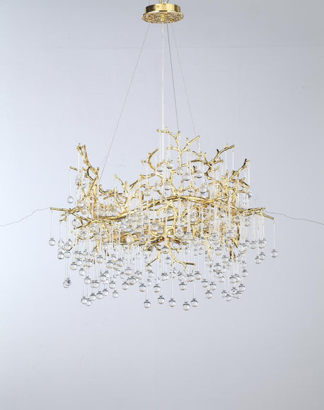 A suspended gold chandelier with a cascading design featuring delicate branches and crystal droplets.