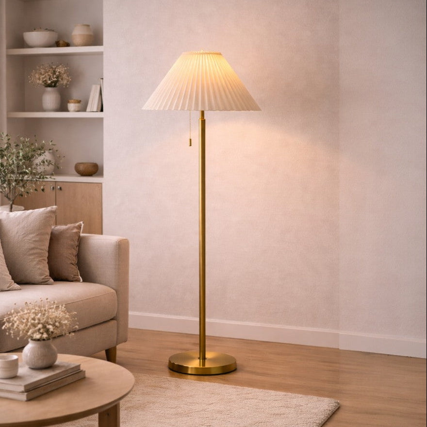 Living room with a beige sofa, coffee table, and standing lamp.