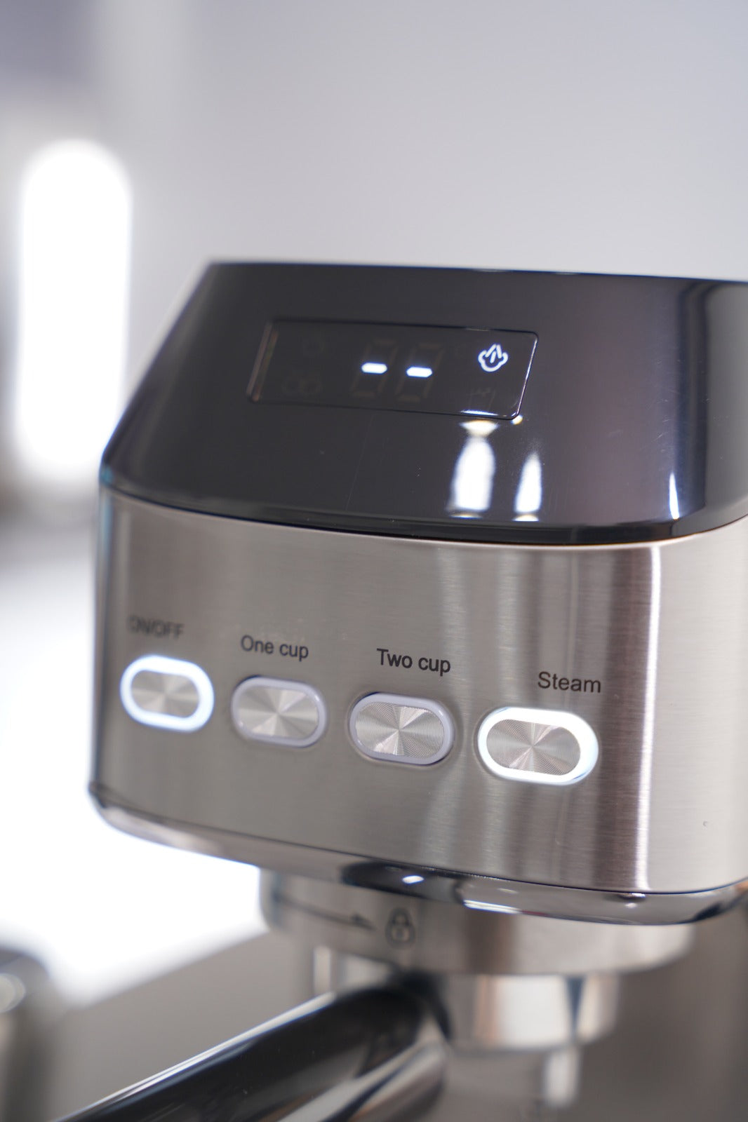 Close-up of a coffee machine with control buttons on a blurred background