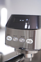 Close-up of a coffee machine with control buttons on a blurred background