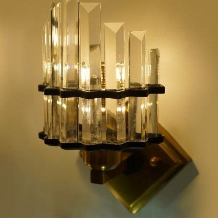 This close-up shot highlights the layered design of the transparent crystal rods, which refract the LED light, producing a warm and dazzling illumination.