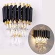 A luxurious lighting fixture composed of sleek black and gold metal rods, adorned with shimmering crystal droplets that hang gracefully. 
